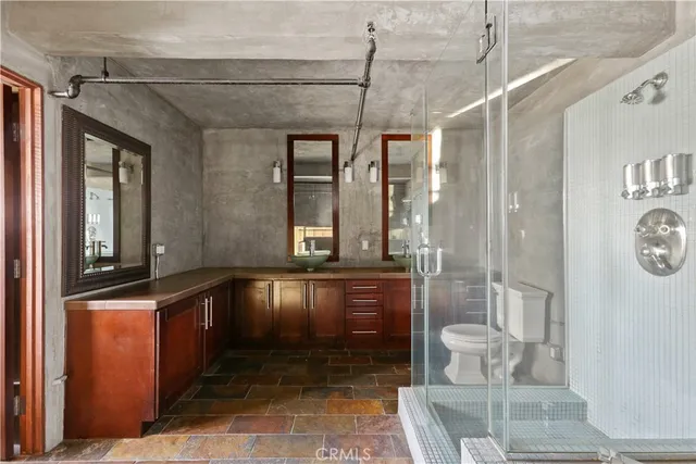 a bathroom with a bathtub a mirror and a shower