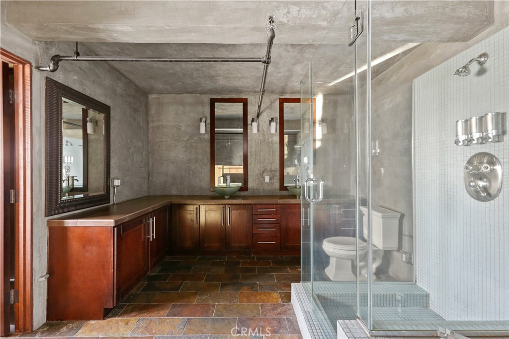 312 West 5th Street, Unit 1204 Los Angeles, CA 90013 - Photo 14 of 22 a bathroom with a bathtub a mirror and a shower