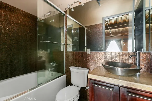a bathroom with a sink a toilet and bathtub