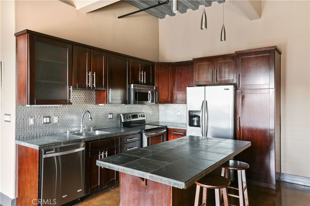 312 West 5th Street, Unit 1204 Los Angeles, CA 90013 - Photo 6 of 22 a kitchen with stainless steel appliances granite countertop a sink a stove and refrigerator