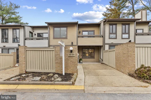 a front view of a house with a yard and seating space