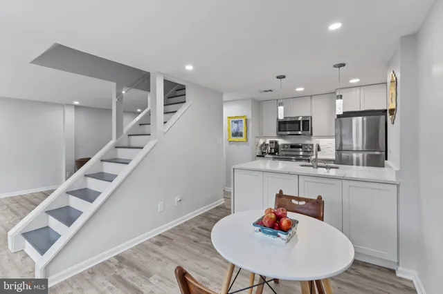 a kitchen with a refrigerator a microwave a sink and stove