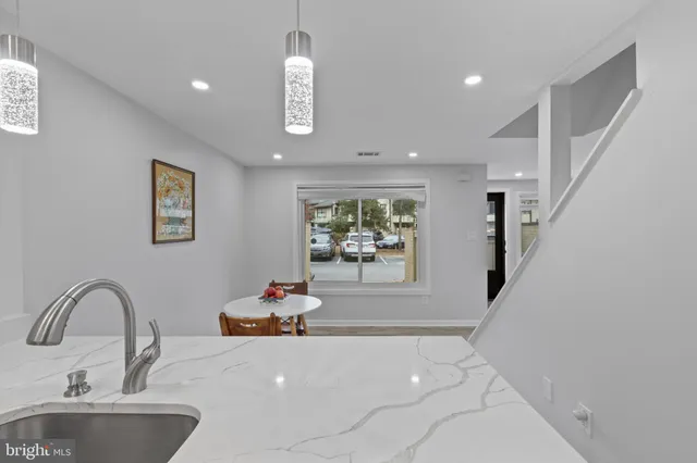 a kitchen with a table and chairs in it