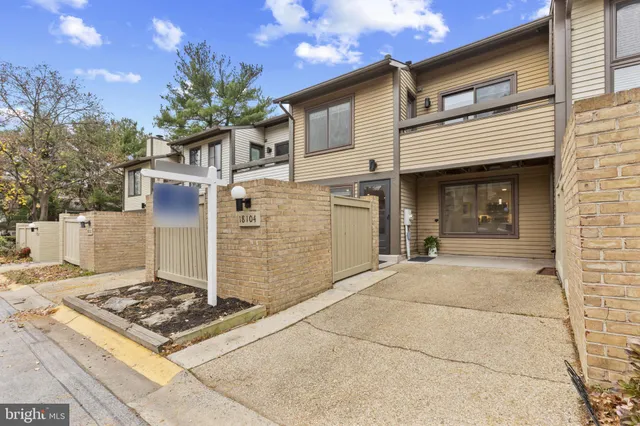 a front view of a house with plants