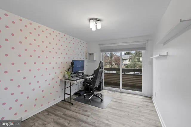 a view of a bedroom with wooden floor