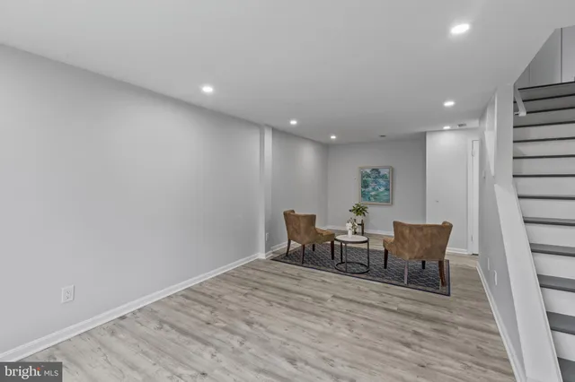 a view of a room with wooden floor