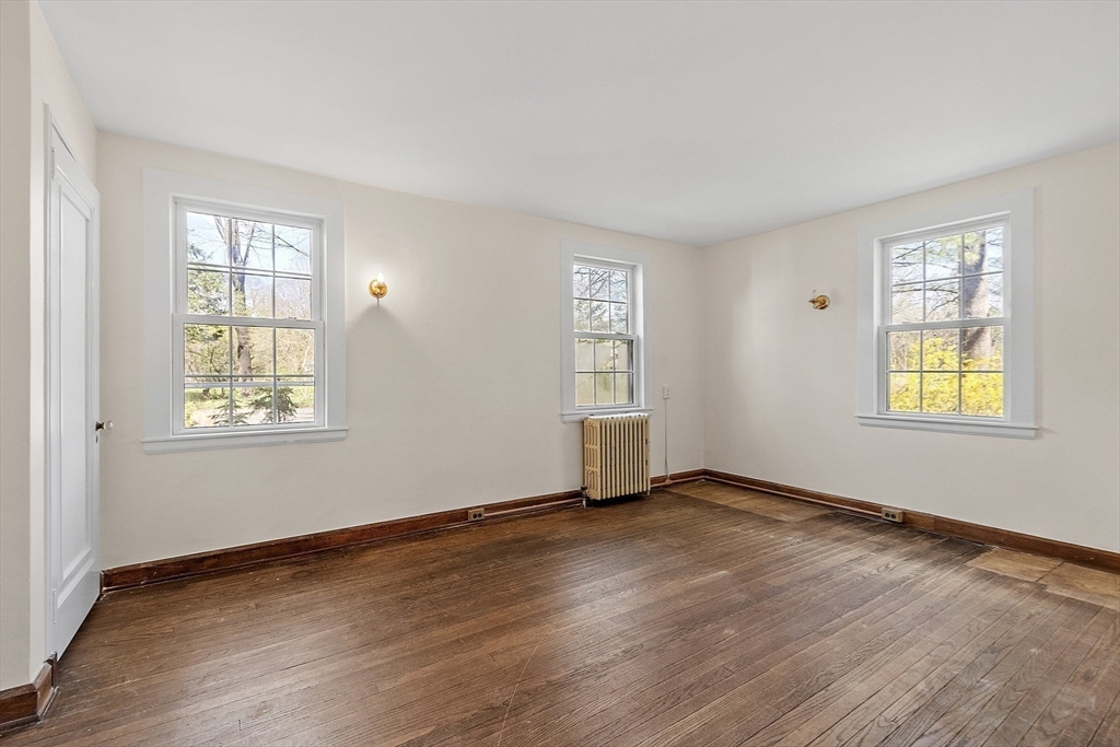 229 Musketaquid Road Concord, MA 01742 - Photo 11 of 21 an empty room with wooden floor and windows