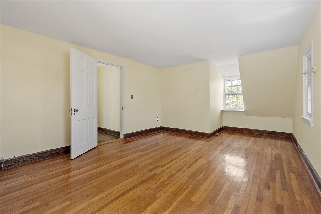 229 Musketaquid Road Concord, MA 01742 - Photo 13 of 21 an empty room with wooden floor and windows