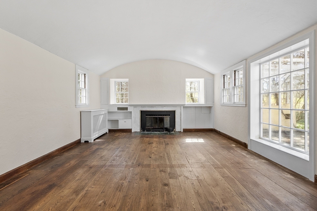 229 Musketaquid Road Concord, MA 01742 - Photo 3 of 21 a view of an empty room with a fireplace and a window