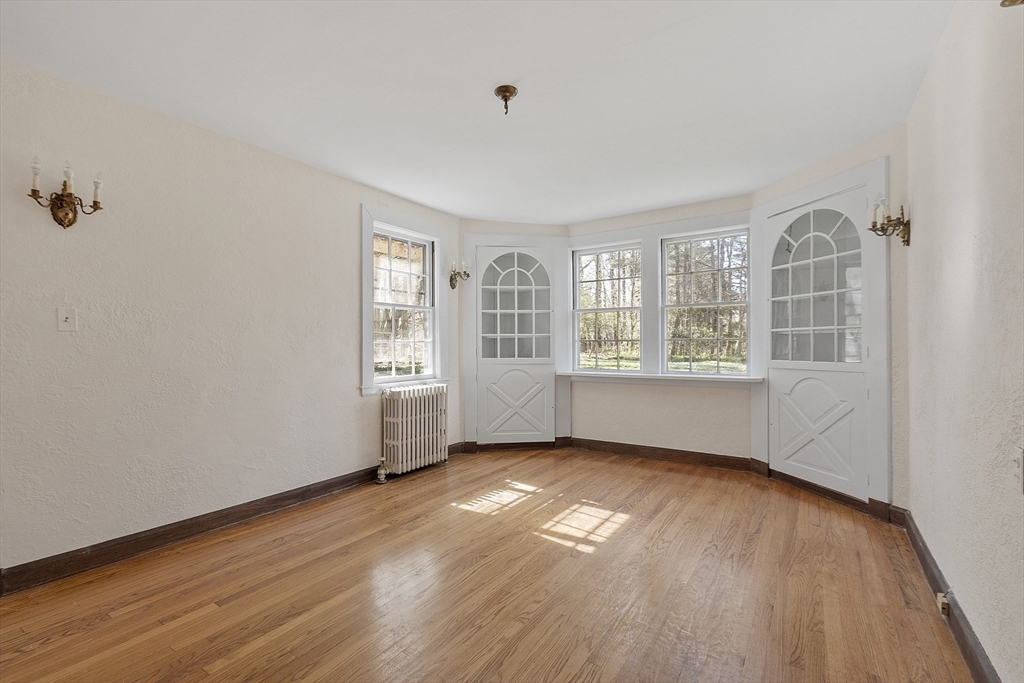 229 Musketaquid Road Concord, MA 01742 - Photo 5 of 21 an empty room with wooden floor and windows