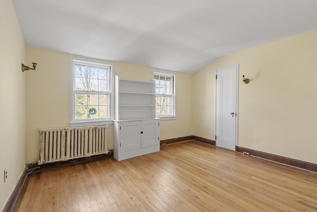229 Musketaquid Road Concord, MA 01742 - Photo 7 of 21 an empty room with wooden floor closet and windows