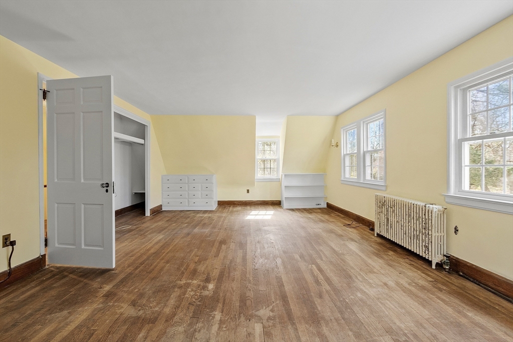 229 Musketaquid Road Concord, MA 01742 - Photo 9 of 21 an empty room with wooden floor and windows