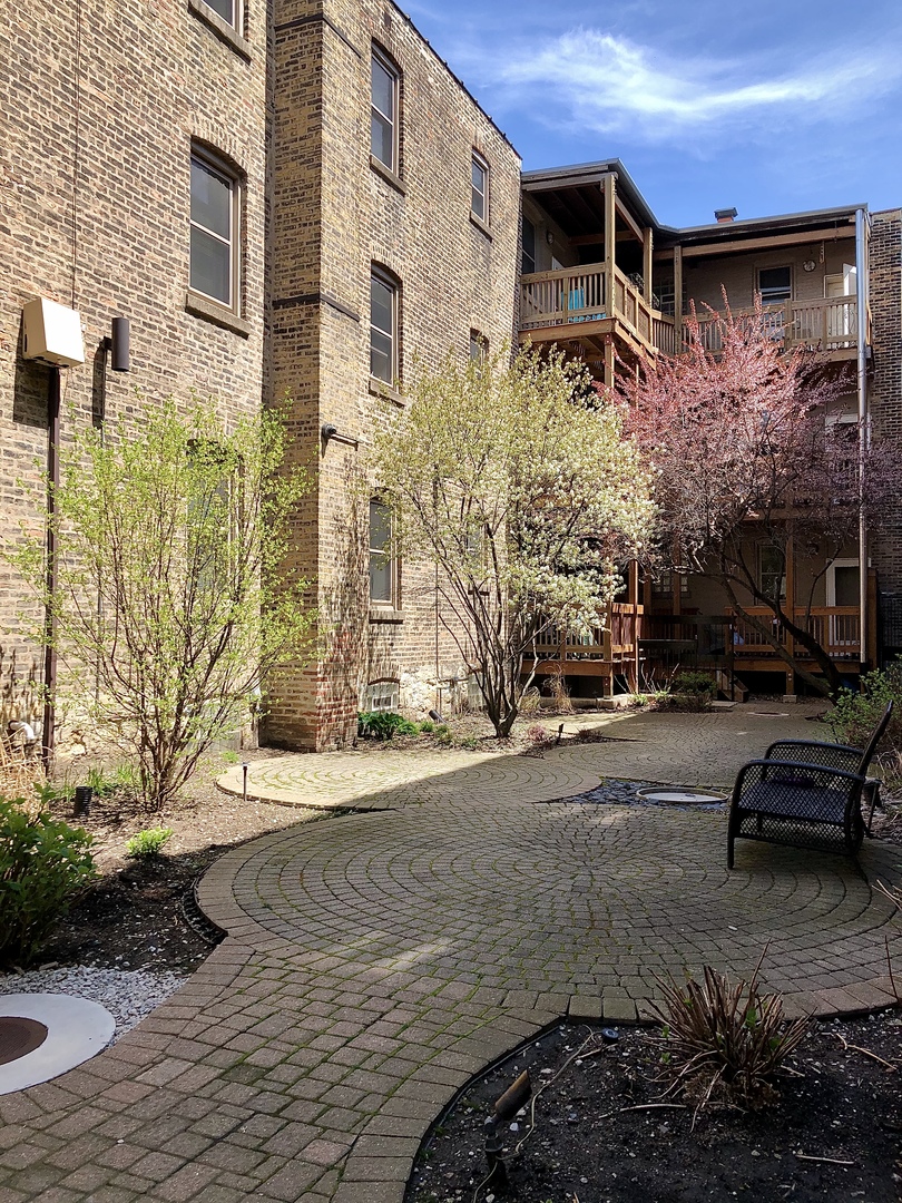 2539 West Iowa Street, Unit 1 Chicago, IL 60622 - Photo 19 of 19 a front view of a house with a yard
