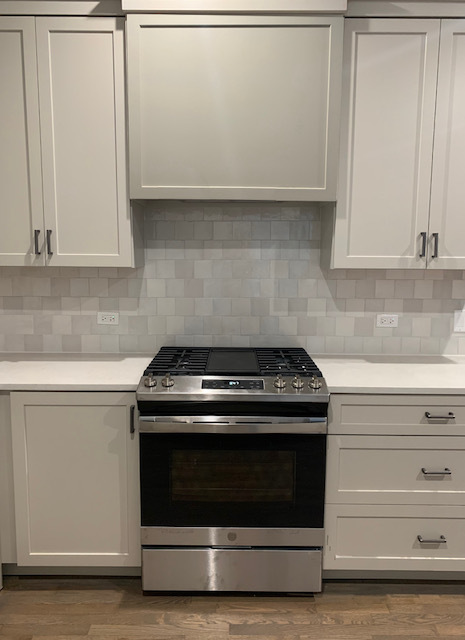 2539 West Iowa Street, Unit 1 Chicago, IL 60622 - Photo 7 of 19 a stove top oven sitting inside of a kitchen