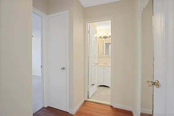 a view of a room with wooden floor closet and mirror