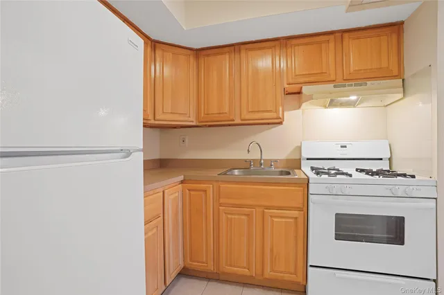 a kitchen with a stove top oven sink and cabinets