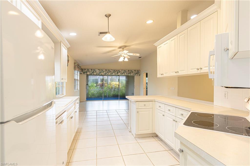 4187 St George Lane Naples, FL 34119 - Photo 11 of 33 a large white kitchen with a large window