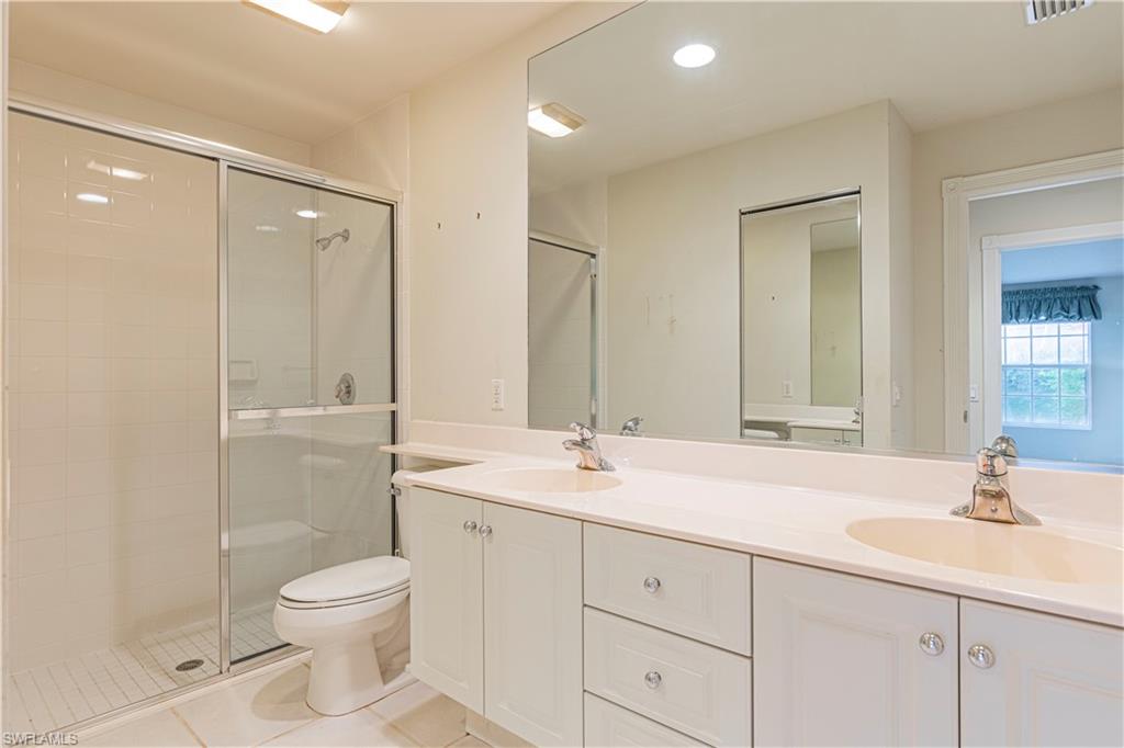 4187 St George Lane Naples, FL 34119 - Photo 16 of 33 a bathroom with a sink a toilet and shower
