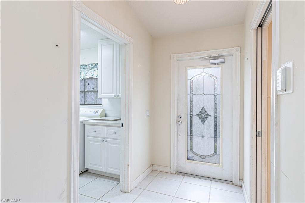 4187 St George Lane Naples, FL 34119 - Photo 20 of 33 a bathroom with a granite countertop sink and a mirror