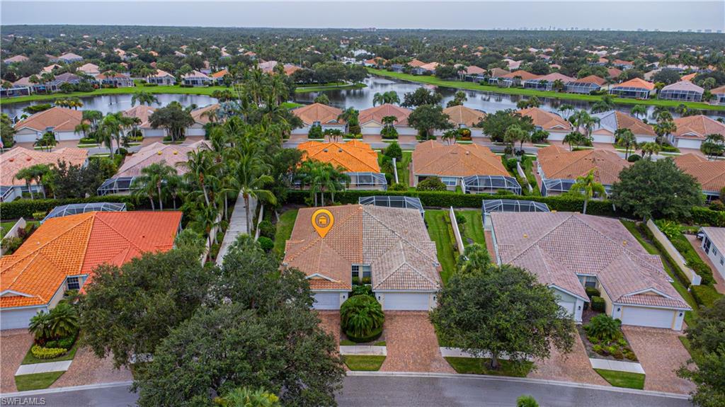 4187 St George Lane Naples, FL 34119 - Photo 4 of 33 an aerial view of residential houses with outdoor space and parking