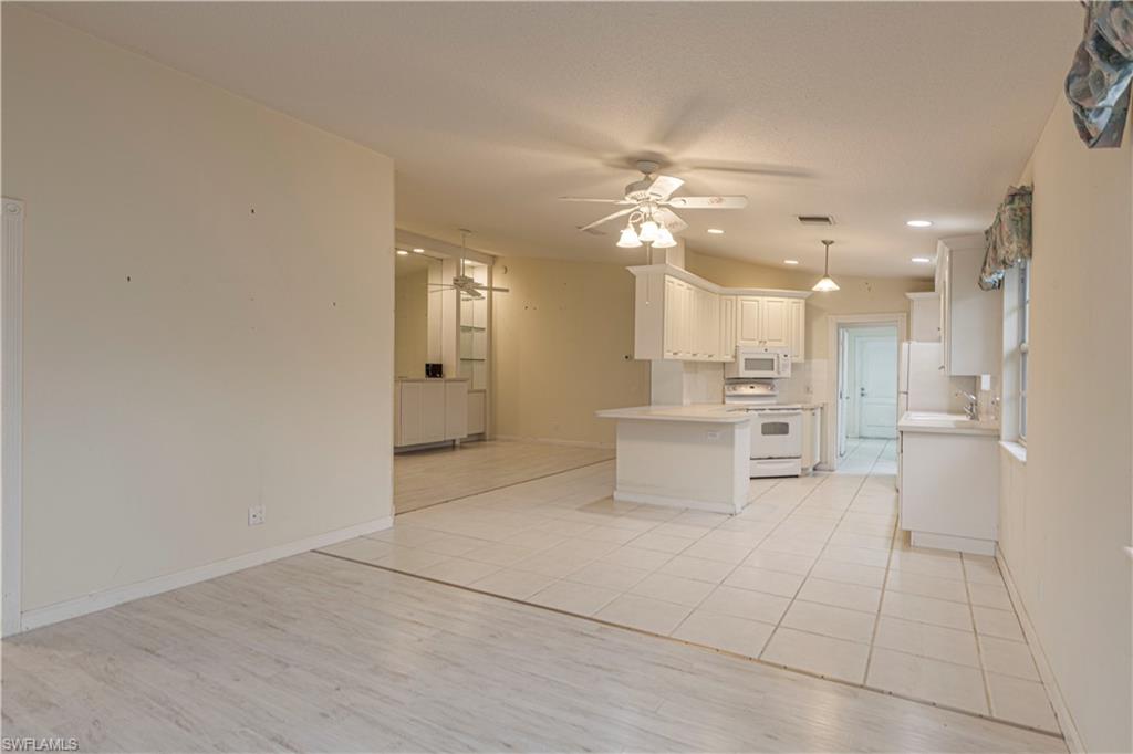 4187 St George Lane Naples, FL 34119 - Photo 7 of 33 a view of a kitchen with furniture and a refrigerator