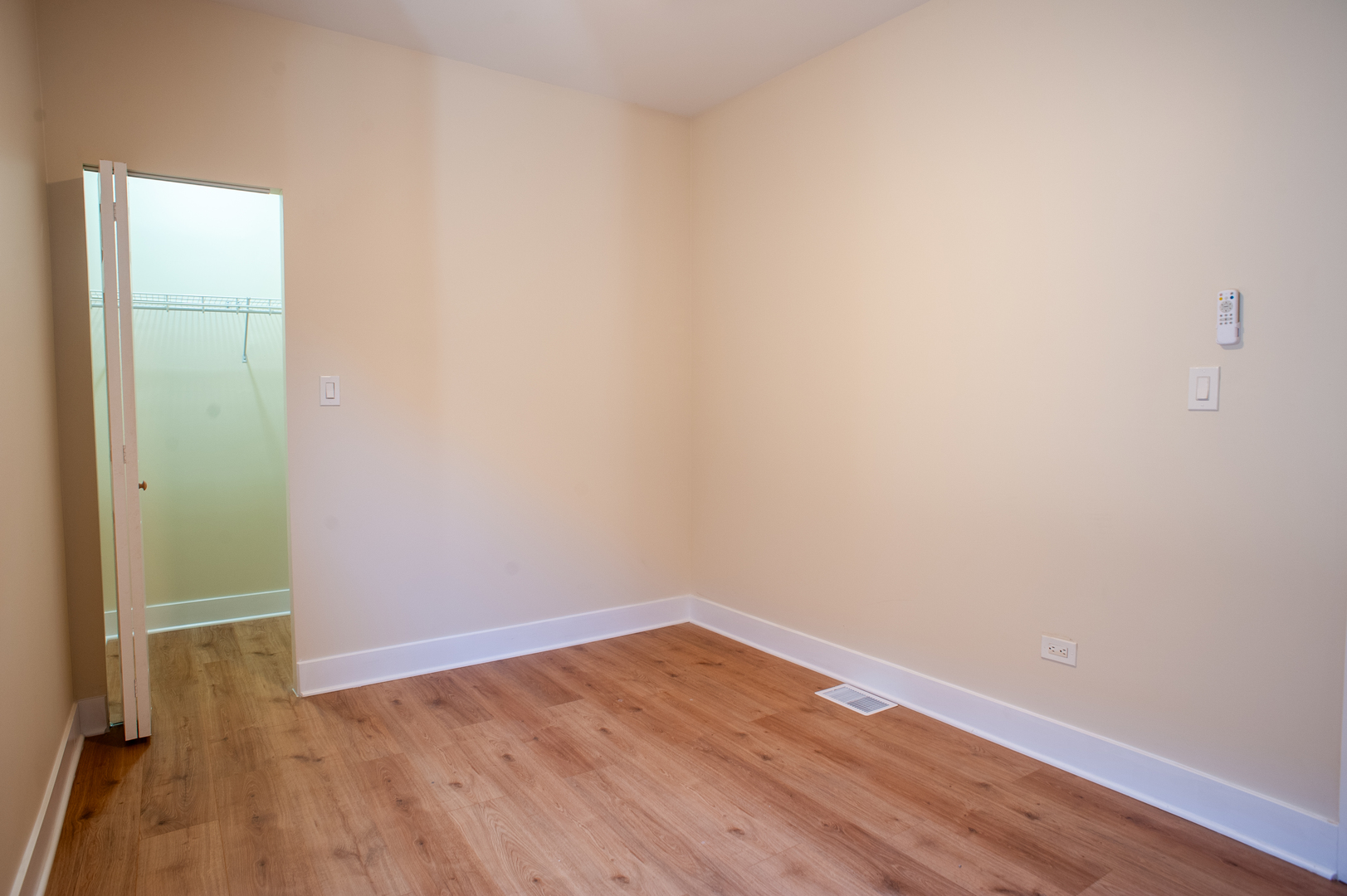 8620 South Union Avenue Chicago, IL 60620 - Photo 14 of 41 a view of an empty room with wooden floor and a window