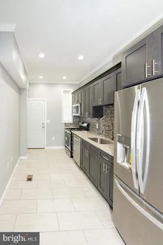 a large kitchen with cabinets and stainless steel appliances