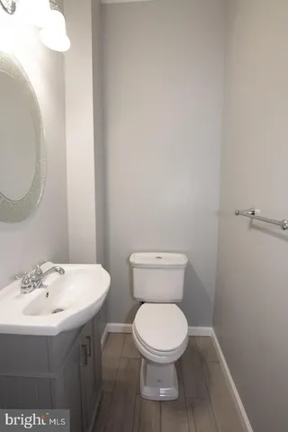 a bathroom with a toilet a sink and a mirror