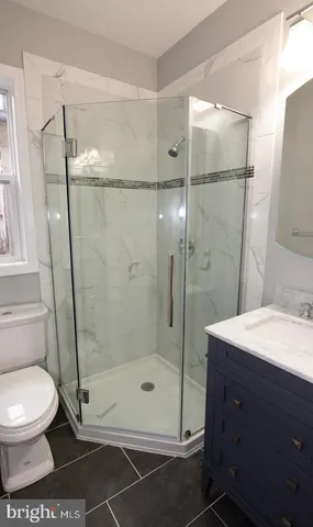 a bathroom with a shower and a toilet