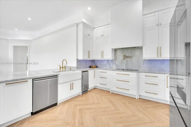 a kitchen with granite countertop a refrigerator and a stove top oven