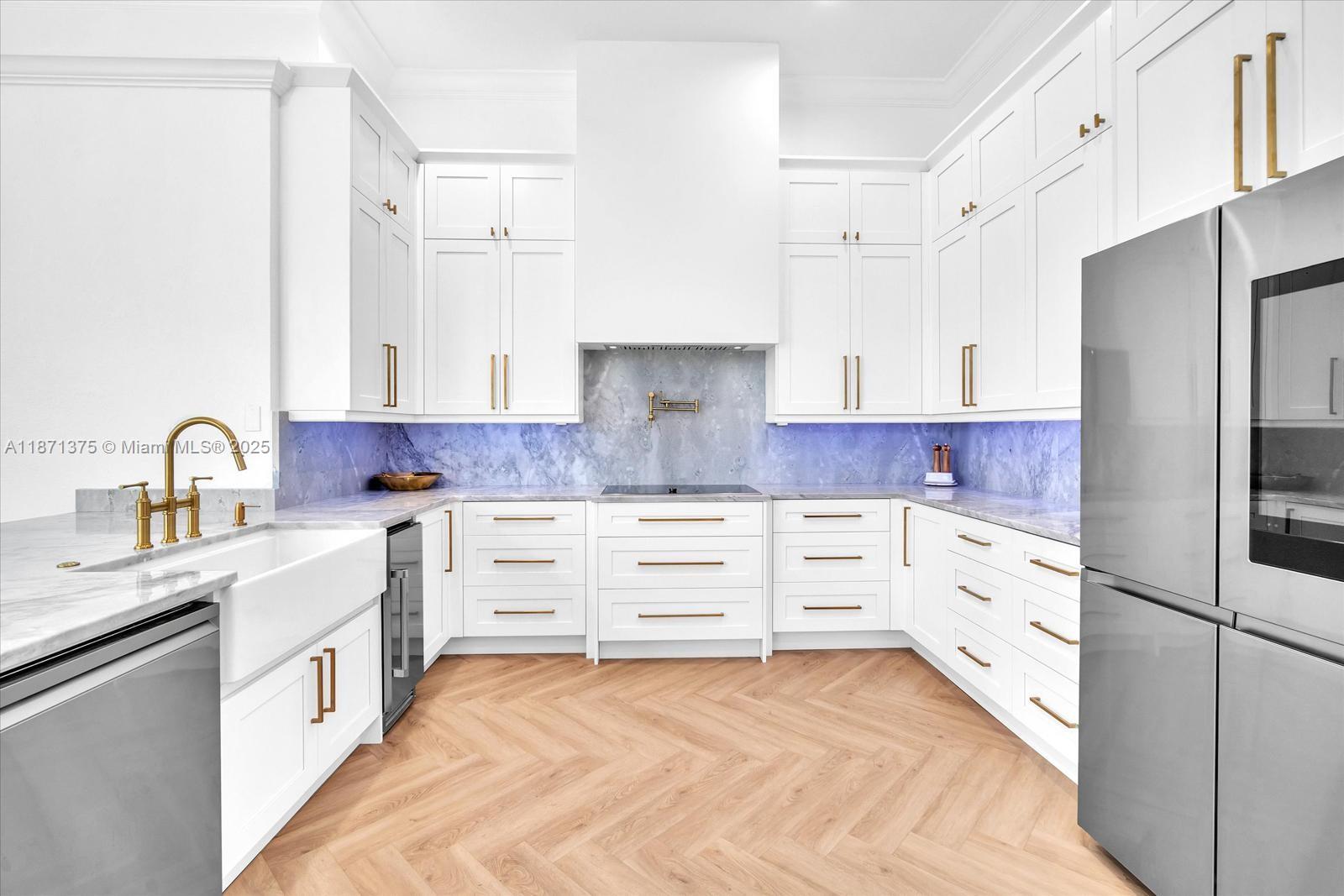 5478 Southwest 189th Avenue, Unit 5478 Miramar, FL 33029 - Photo 14 of 58 a kitchen with white cabinets and stainless steel appliances