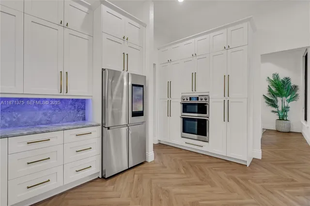 a kitchen with stainless steel appliances a refrigerator and a stove