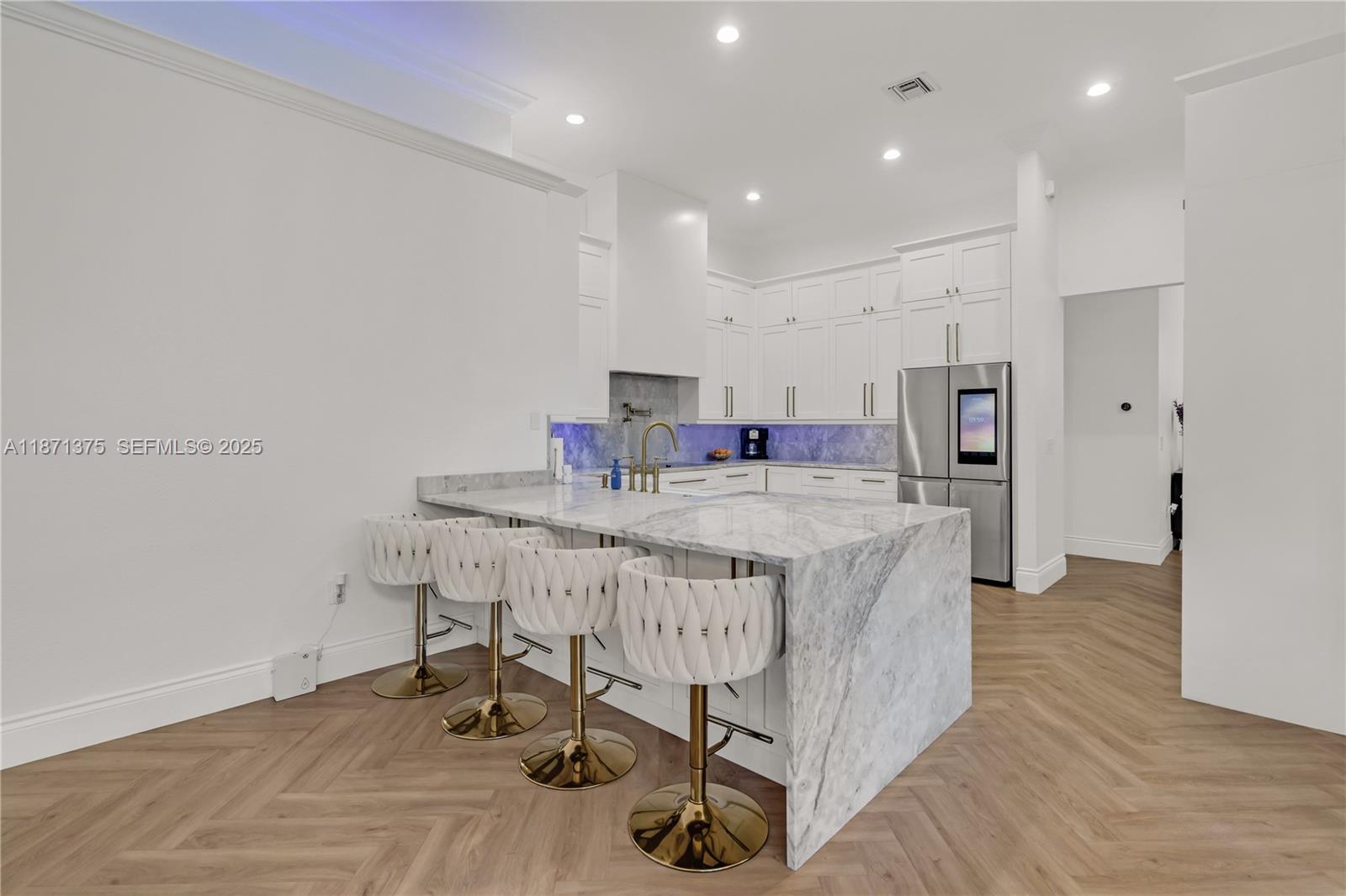 5478 Southwest 189th Avenue, Unit 5478 Miramar, FL 33029 - Photo 20 of 58 a kitchen with kitchen island a sink appliances and wooden floor