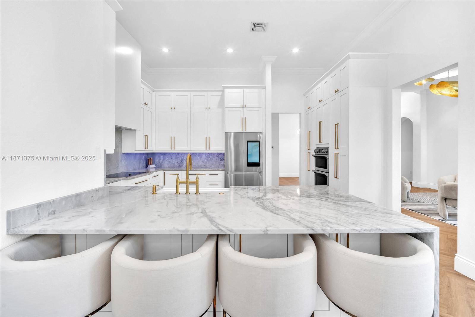 5478 Southwest 189th Avenue, Unit 5478 Miramar, FL 33029 - Photo 22 of 58 a kitchen with kitchen island stainless steel appliances a sink and white cabinets