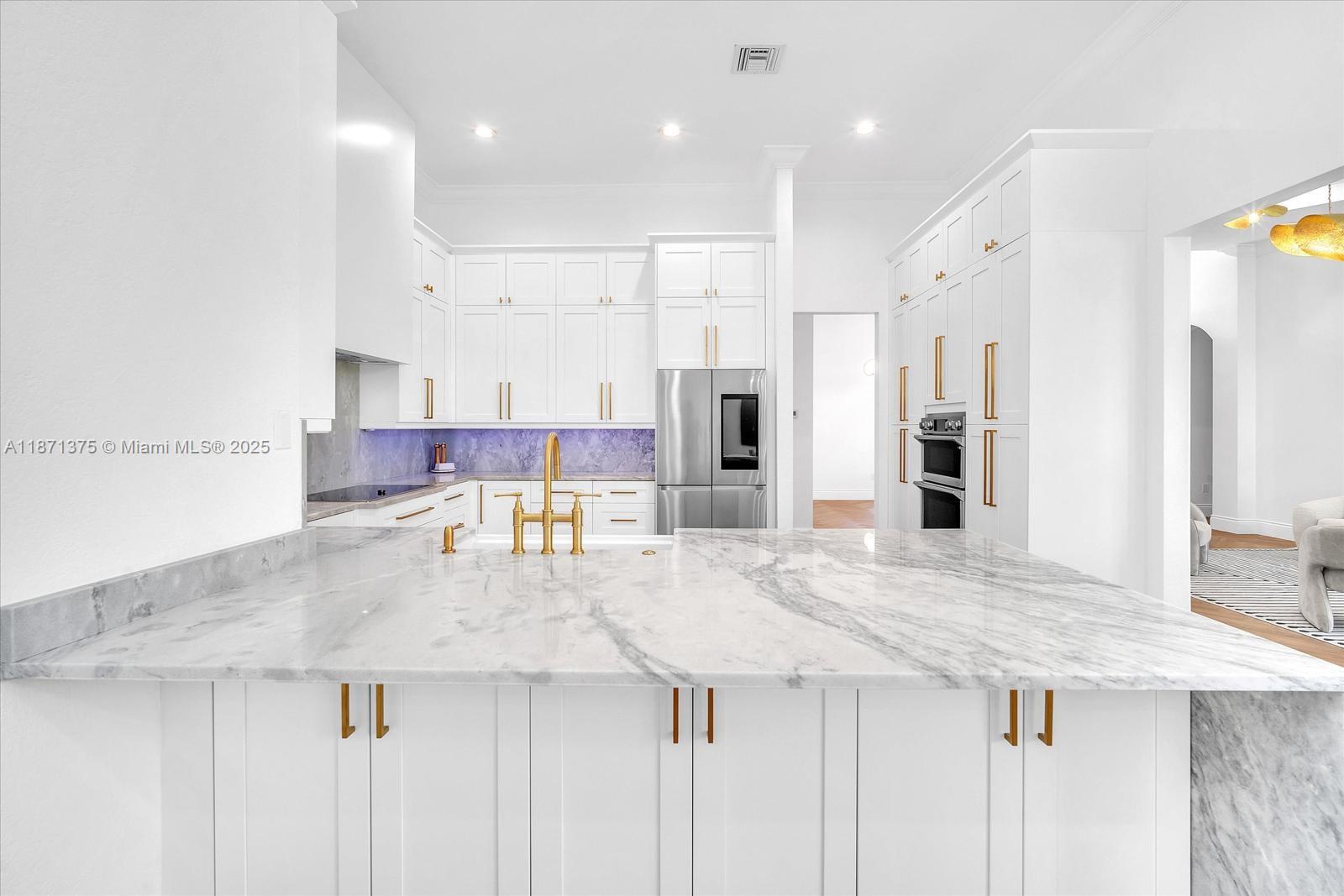 5478 Southwest 189th Avenue, Unit 5478 Miramar, FL 33029 - Photo 23 of 58 a kitchen with stainless steel appliances kitchen island a large counter top and a refrigerator