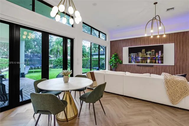 a spacious bedroom with a large bed and a chandelier