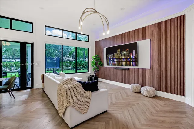 a bedroom with a bed a dresser and flat screen tv