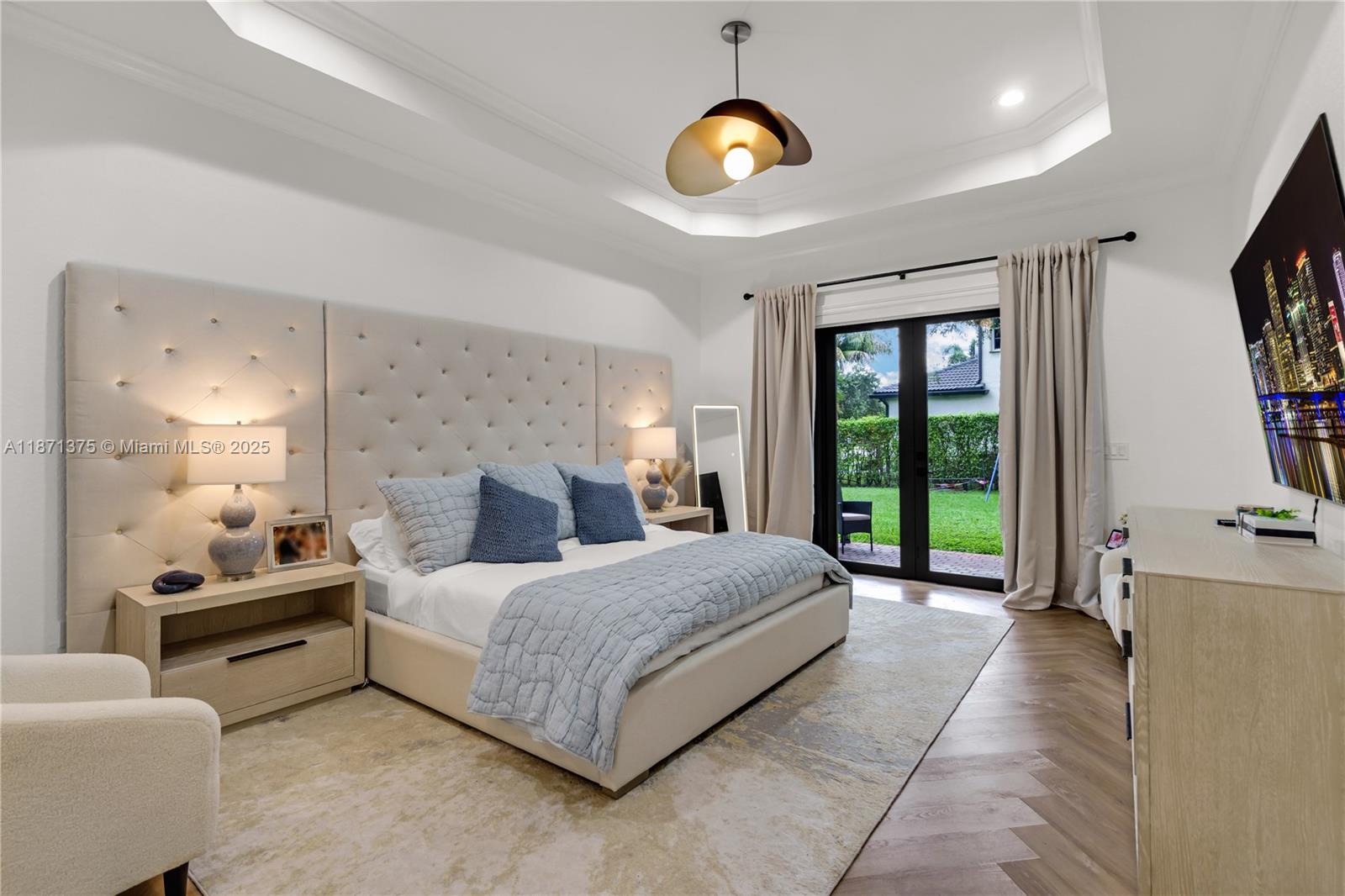 5478 Southwest 189th Avenue, Unit 5478 Miramar, FL 33029 - Photo 28 of 58 a spacious bedroom with a large bed and a chandelier