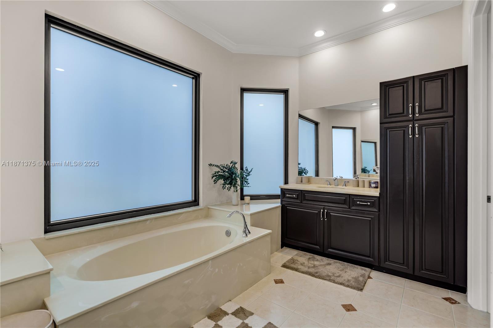 5478 Southwest 189th Avenue, Unit 5478 Miramar, FL 33029 - Photo 34 of 58 a bathroom with a bathtub sink and mirror