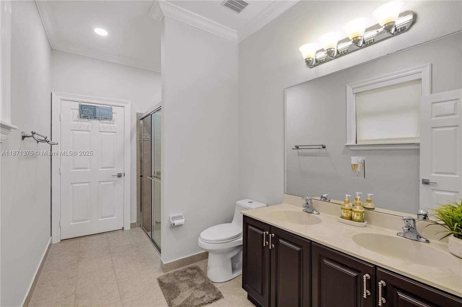 5478 Southwest 189th Avenue, Unit 5478 Miramar, FL 33029 - Photo 39 of 58 a spacious bathroom with a granite countertop sink a toilet and a mirror