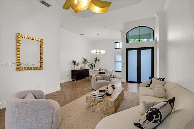 a living room with furniture a mirror and lamp