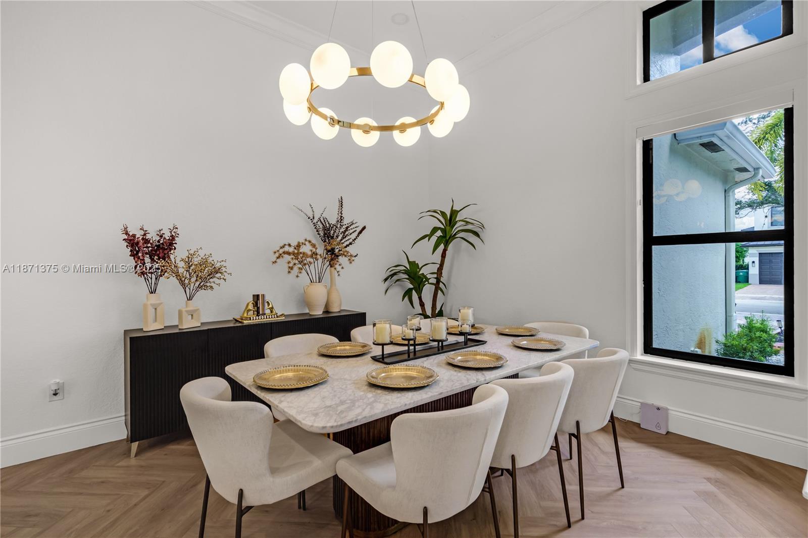 5478 Southwest 189th Avenue, Unit 5478 Miramar, FL 33029 - Photo 10 of 58 a view of a dining room with furniture a chandelier and wooden floor