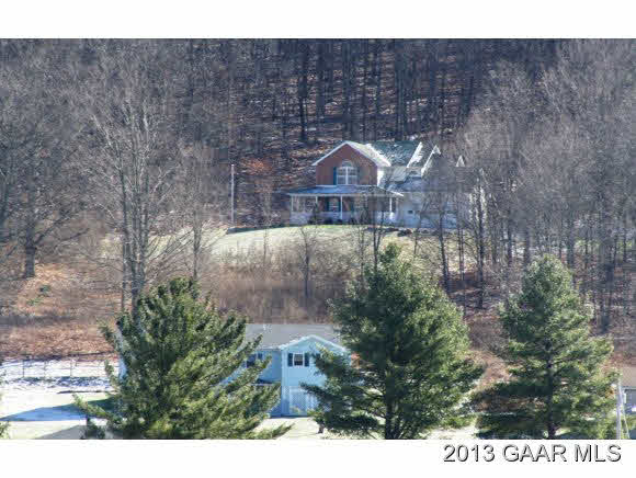 134 Overlook Road Monterey, VA 24465 - Photo 1 of 36 a front view of a house with a yard and large tree
