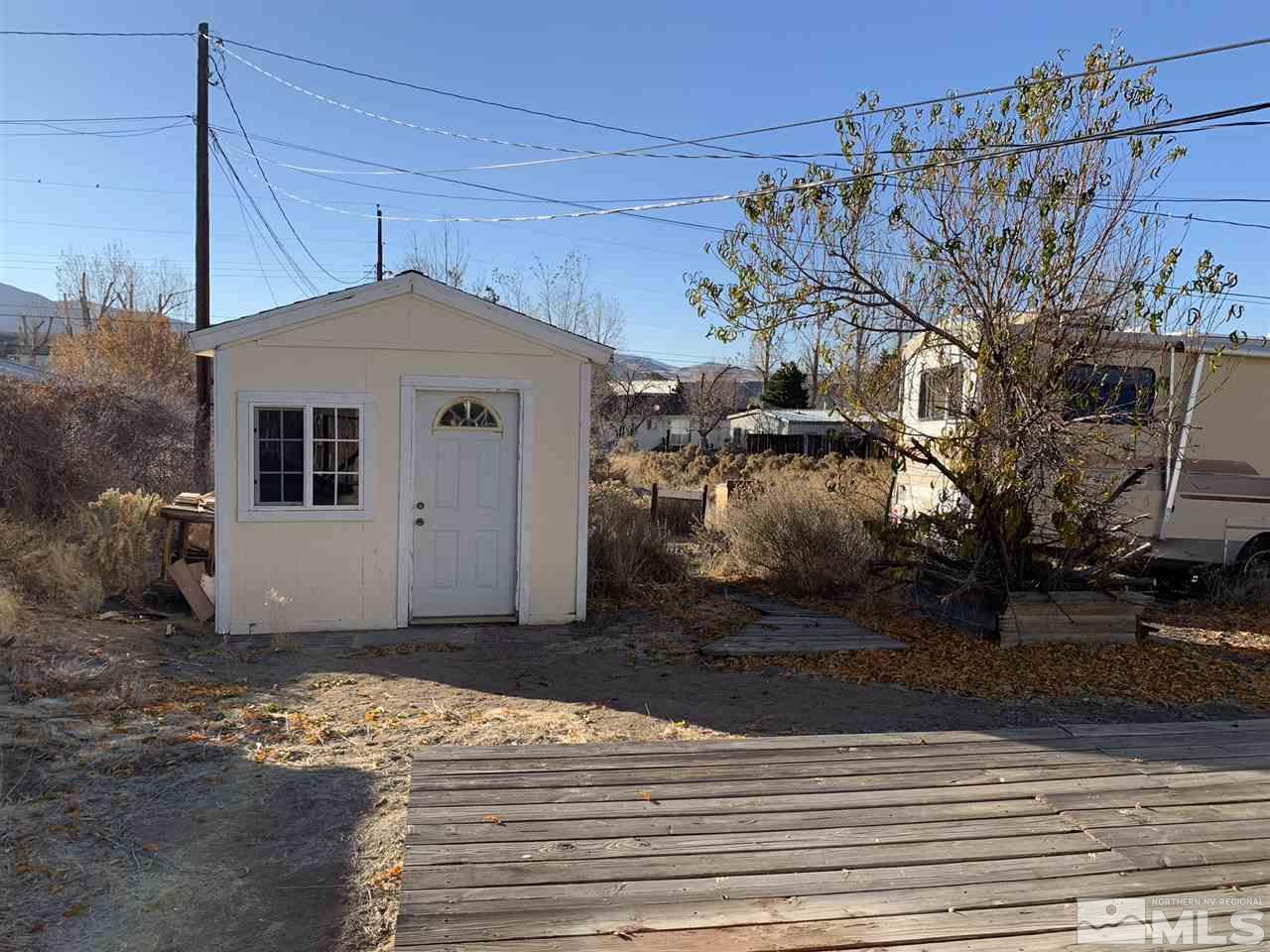 8579 Aquifer Way Reno, NV 89506 - Photo 14 of 17 a front view of a house with a yard
