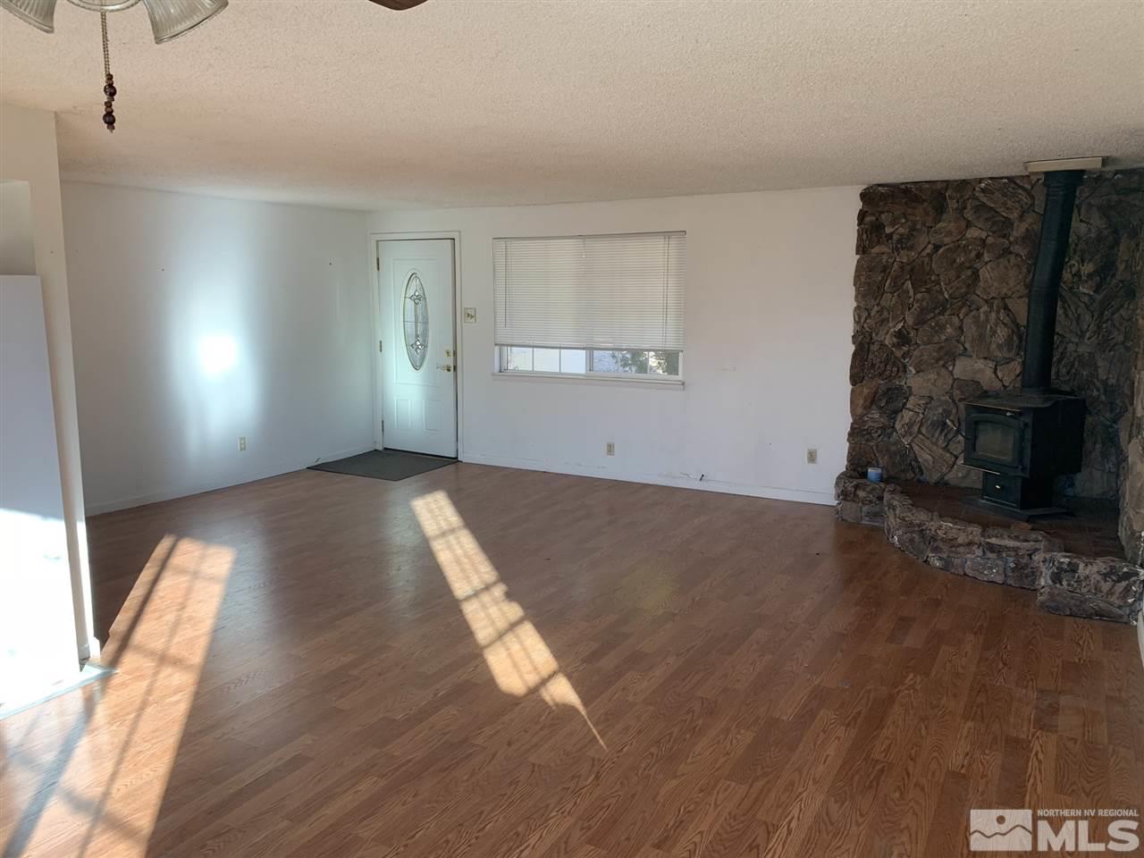 8579 Aquifer Way Reno, NV 89506 - Photo 5 of 17 a view of empty room with wooden floor and fan