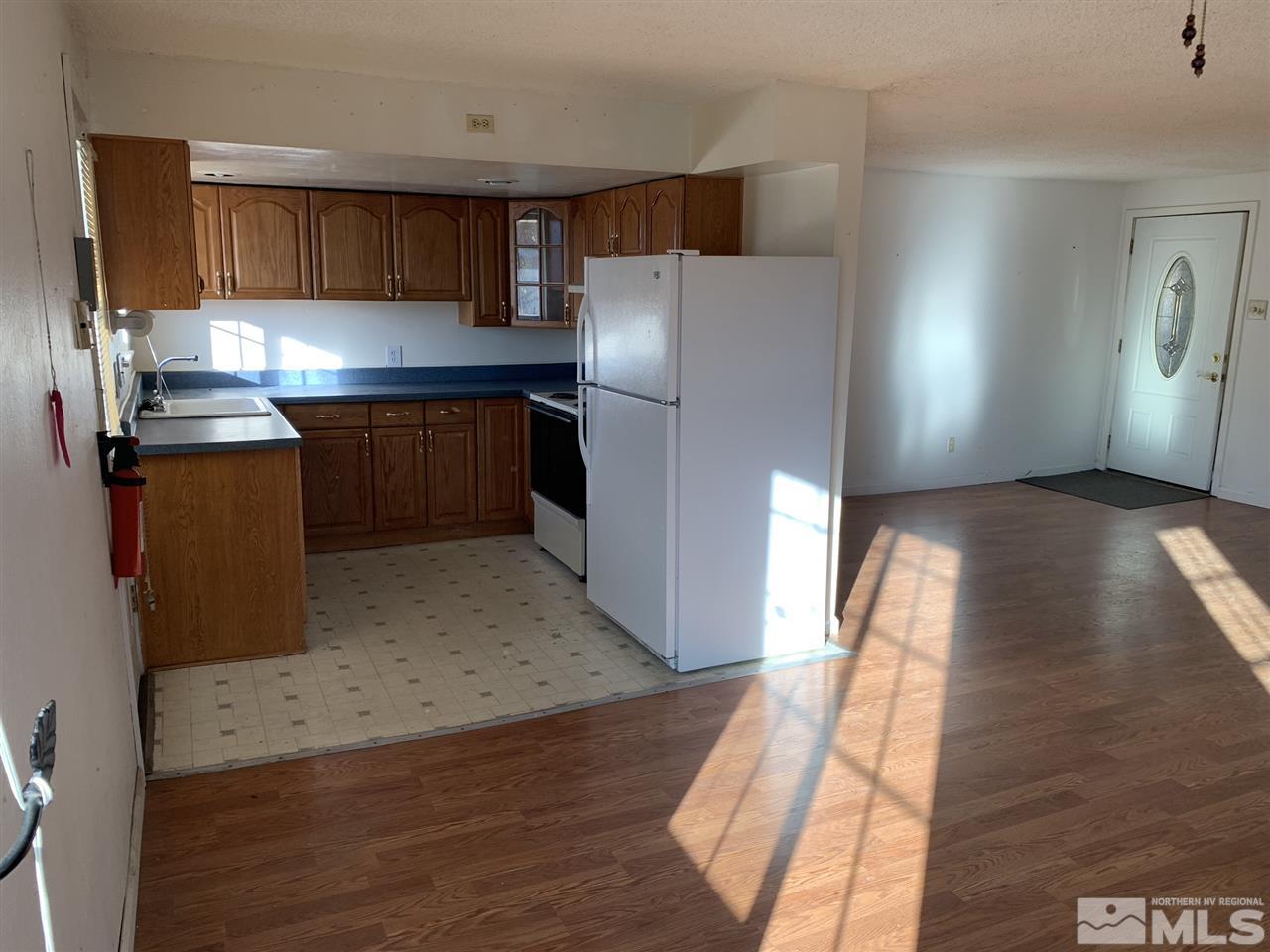 8579 Aquifer Way Reno, NV 89506 - Photo 7 of 17 a kitchen with granite countertop a refrigerator and a sink