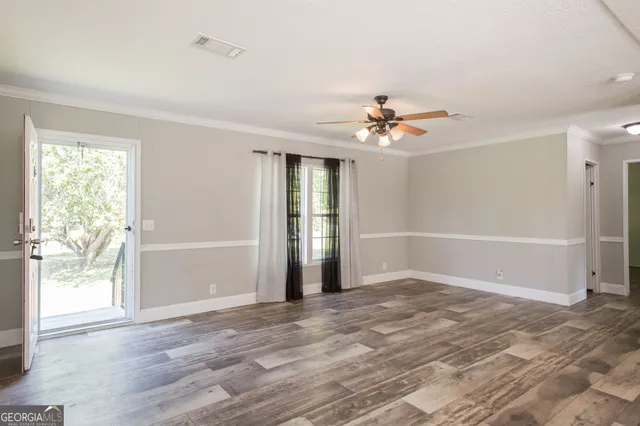 wooden floor in an empty room with a window