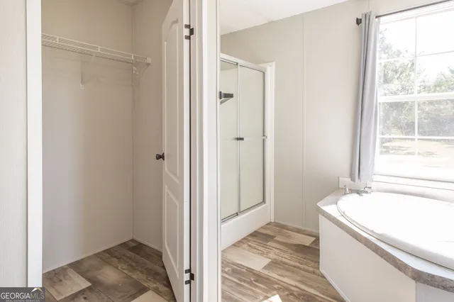 a bathroom with a tub and shower