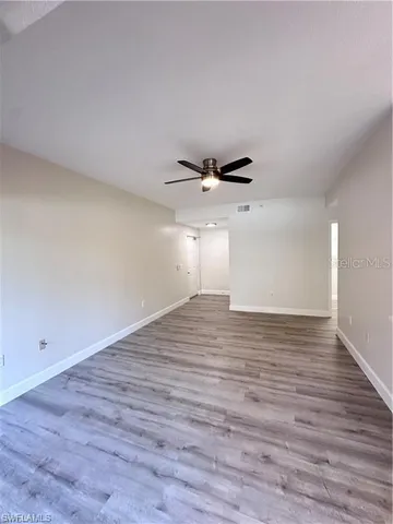 a view of a room with wooden floor