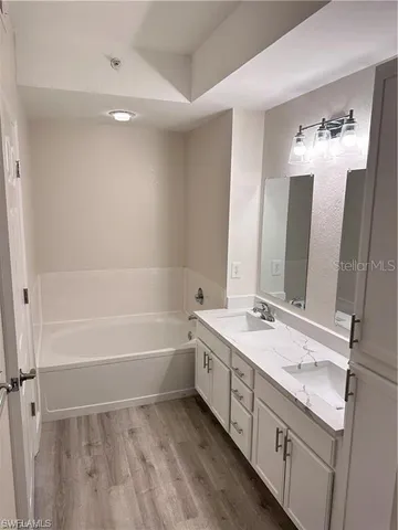 a bathroom with a double vanity sink and mirror